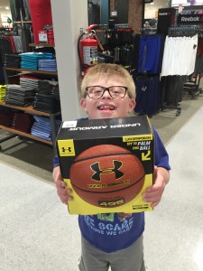 Alex holds up his basketball for Santa